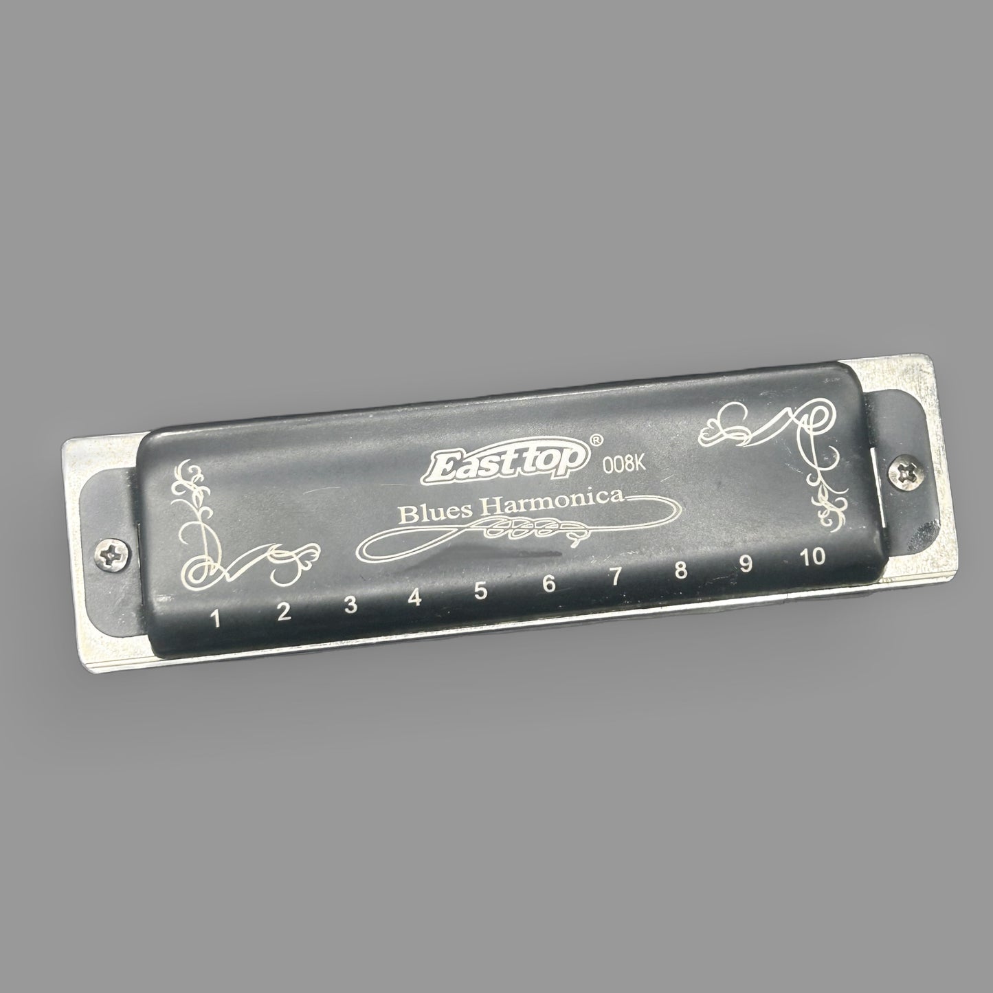Easttop T008K 10-Hole Diatonic Blues Harmonica — Engraved Black Cover — detail view