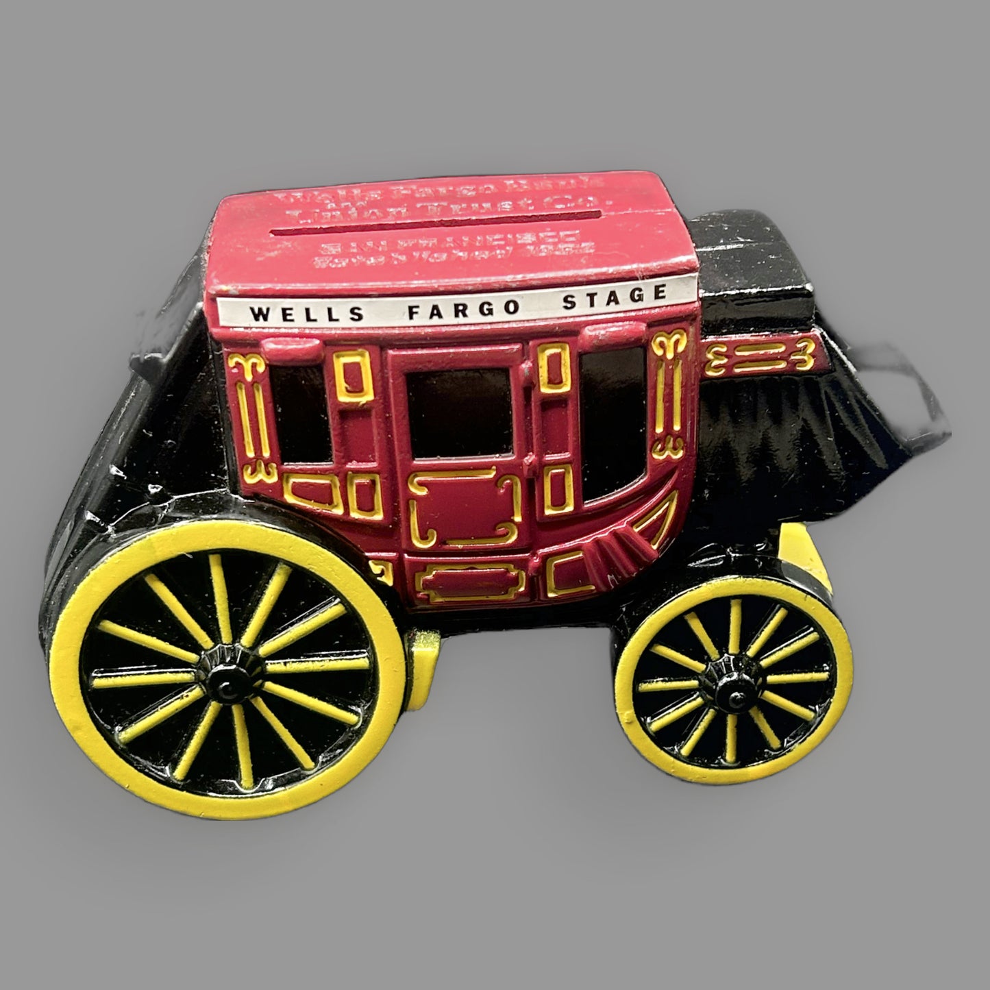 Wells Fargo Stagecoach Cast Iron Coin Bank — Red, Black & Yellow — detail view