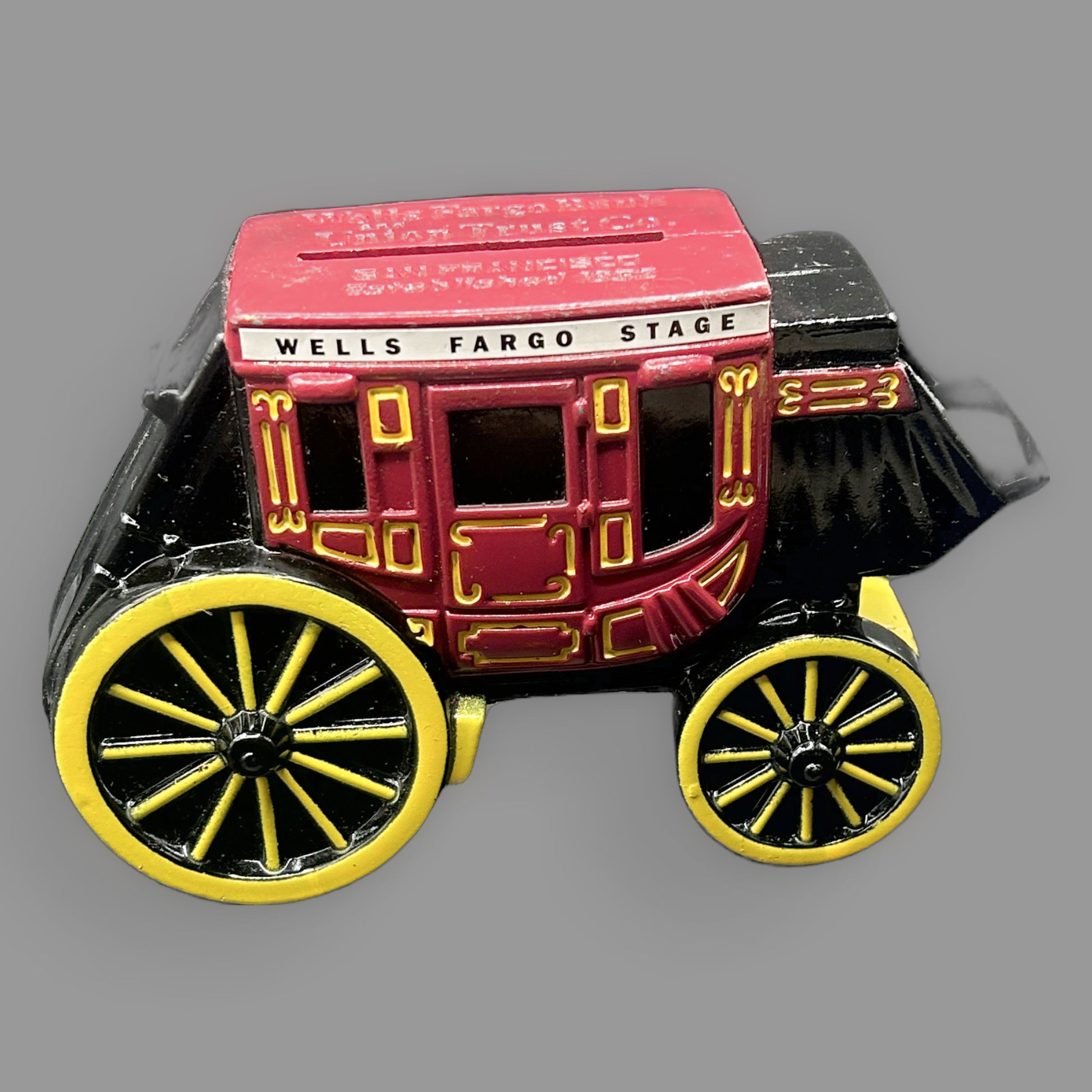 Wells Fargo Stagecoach Cast Iron Coin Bank — Red, Black & Yellow — detail view